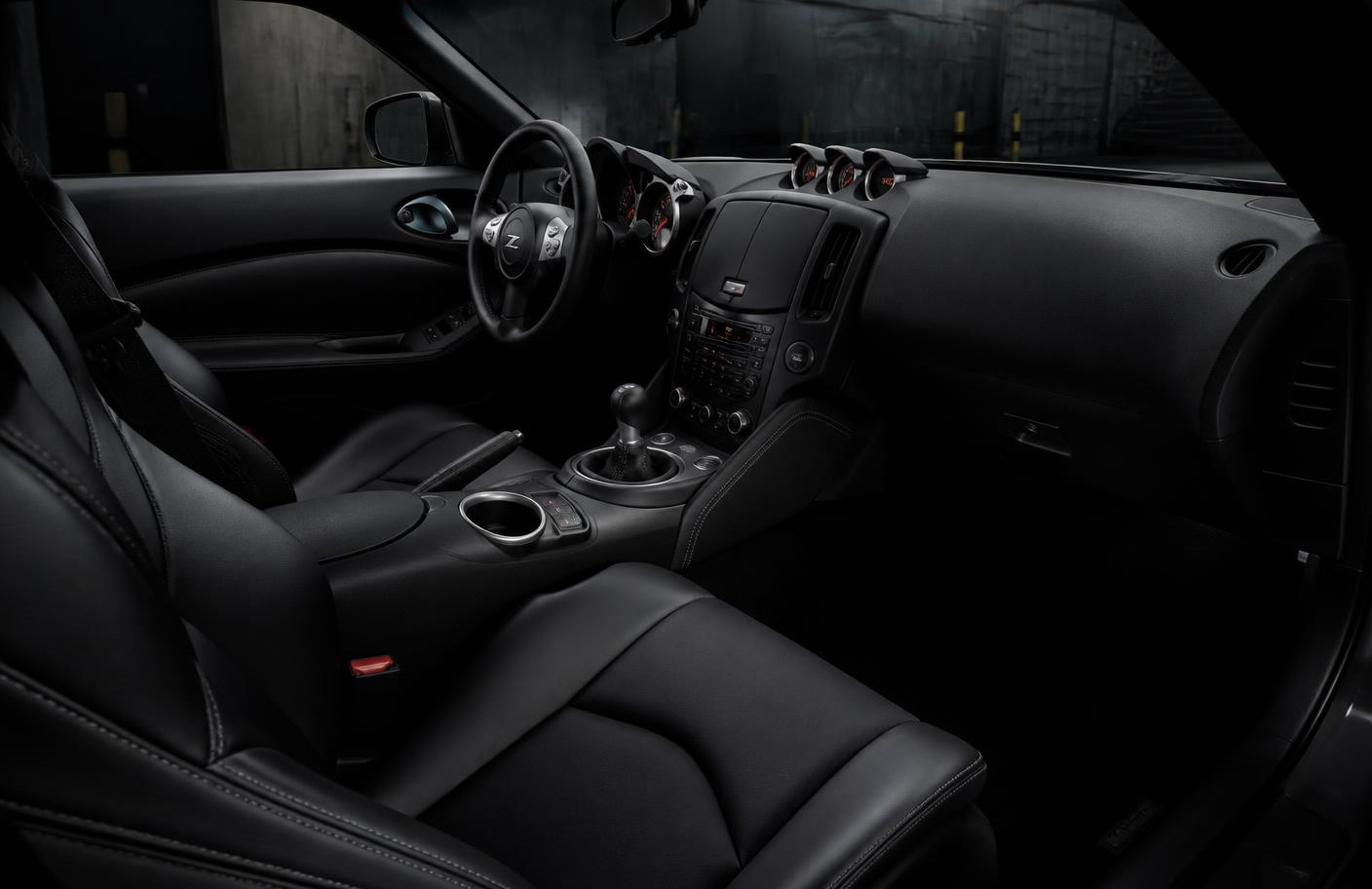 Freshly detailed dark car interior with clean leather seats and dashboard